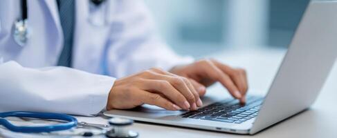 The medical professional using a laptop for patient care and communication. photo