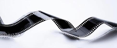The elegant curve of a film strip against a light backdrop. photo