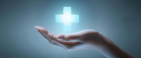 The hand supporting a glowing healthcare symbol for medical assistance. photo