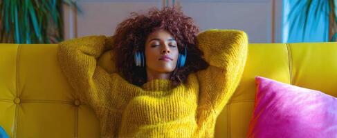 The woman enjoying a peaceful moment while listening to music on her couch. photo