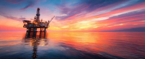 The breathtaking oil rig silhouetted against a vibrant sunset over the ocean. photo