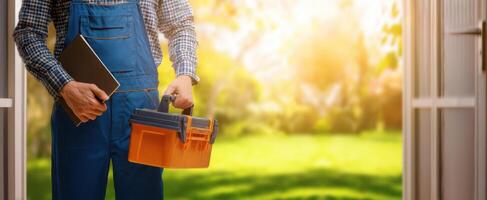 The dedicated worker stepping outside with a toolbox and notebook in hand. photo