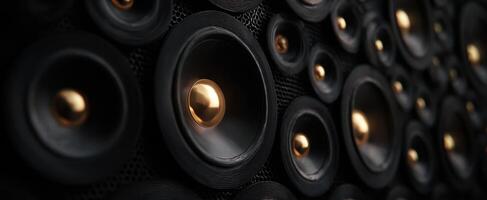 The collection of stylish black speakers with golden accents for audio enthusiasts. photo