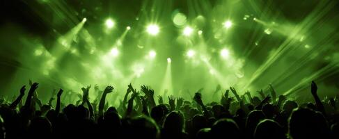 The vibrant crowd enjoying a dynamic concert experience with green lights. photo