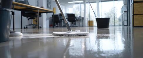 The cleaning process in a modern office space with a mop and bucket. photo