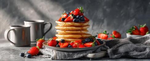 Stack of pancakes with berries and strawberries on a plate photo