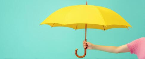The vibrant yellow umbrella adding style against a turquoise backdrop. photo