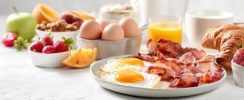 The mouthwatering breakfast spread with eggs, bacon, and fresh fruits. photo