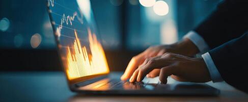 The laptop displaying financial data with hands working efficiently. photo