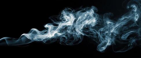 The ethereal dance of smoke against a black background. photo