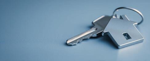 The keys to your new home resting on a blue background. photo