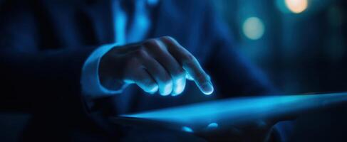 The businessman interacting with a glowing tablet screen in a modern environment. photo