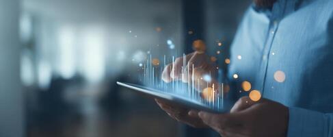 The professional using a tablet to analyze data and visualizations in a modern workspace. photo