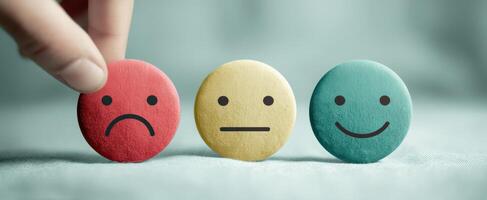 The colorful emotion icons representing happiness, neutrality, and sadness in a thoughtful arrangement. photo