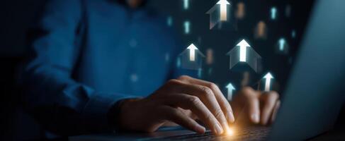 The hands of a professional typing on a laptop with arrows symbolizing growth. photo
