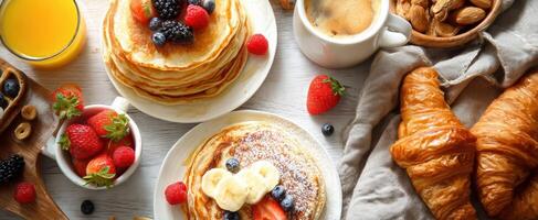 The delicious pancakes served with fresh berries and coffee in a cozy breakfast setting. photo