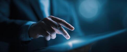 The hand engaging with a tablet in a modern business environment. photo