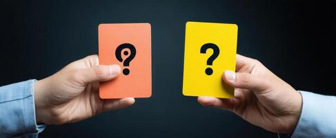 The hands holding colorful question cards symbolizing decision-making and choice. photo