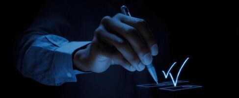 The hand writing a digital checkmark in a modern interface design. photo