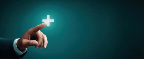 The hand pressing a glowing plus symbol representing growth and opportunity. photo