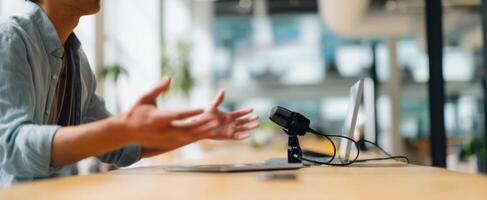 The person communicating passionately during an online meeting with a microphone. photo