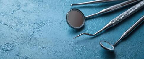 The dental instruments arranged on a blue textured background for healthcare. photo