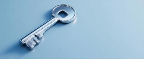 The shiny silver key resting on a smooth blue background. photo