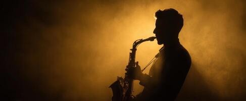 The saxophone player in silhouette against a dramatic smoky backdrop photo