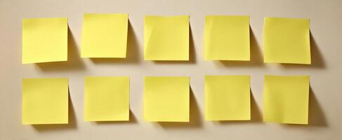 The collection of blank yellow sticky notes on a simple background. photo