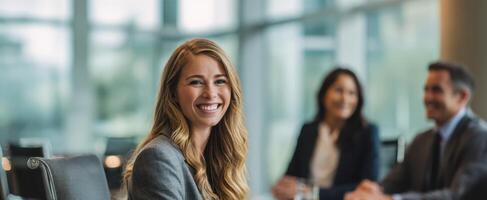 The confident businesswoman smiling during a collaborative team meeting in the office. photo