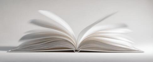 The open book with pages in motion on a minimalist background photo
