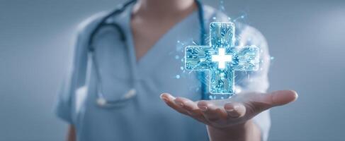 The healthcare professional presenting a digital medical cross in their hand. photo