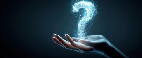The Glowing Question Mark Floating Above a Hand in a Dark Environment. photo