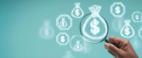The magnifying glass focusing on money symbols for financial analysis. photo