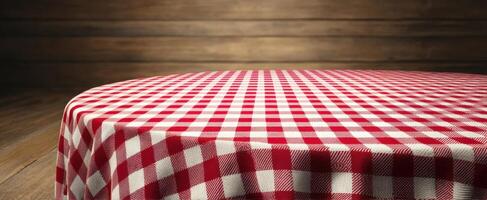 The checkered tablecloth on a round wooden table creates a cozy atmosphere. photo