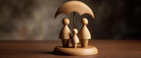 The wooden family figurines under an umbrella symbolizing protection and love. photo