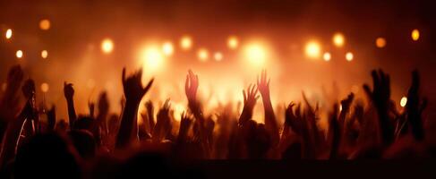 The vibrant crowd celebrating at a music festival under bright lights. photo