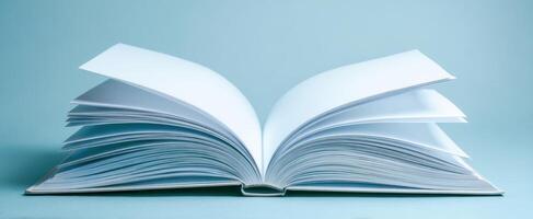 The open book with blank pages on a serene blue background photo