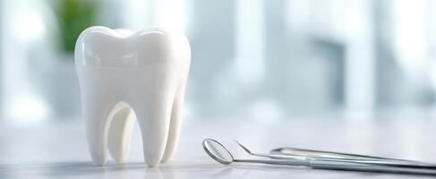 The shiny tooth on a clean dentist's table with dental tools nearby. photo