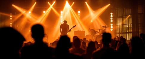 The guitarist shines under vibrant lights at a live music concert. photo