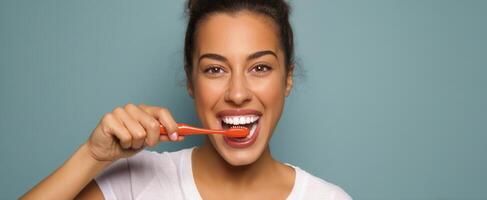 The woman brushing her teeth with a bright smile in a vibrant setting. photo