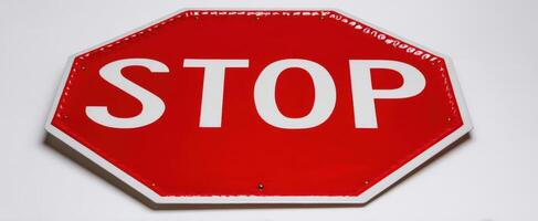 The stop sign indicating safety and traffic regulations for drivers. photo