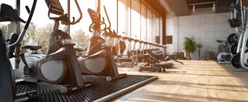 The modern gym features an array of cardio equipment and sleek design. photo