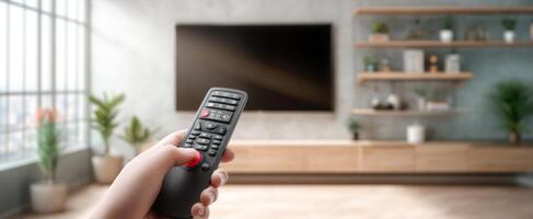 The remote control in a modern living room with a television screen. photo