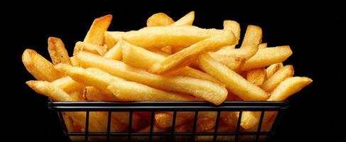 The basket of golden fries with a crispy texture and delicious aroma. photo