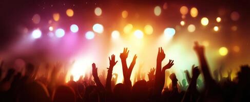 The crowd celebrating under vibrant lights at a live concert event. photo