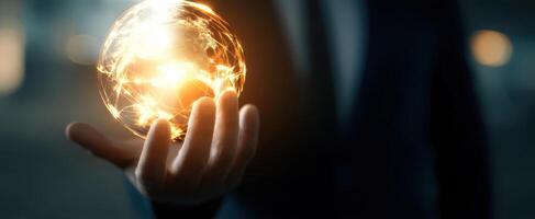 The glowing globe in hand representing global connectivity and innovation. photo