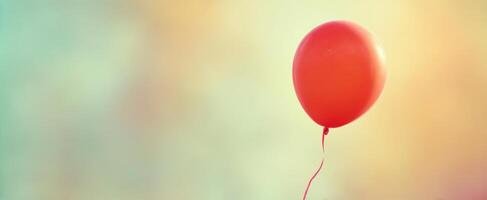 The Red Balloon Floating Gently Against a Soft Pastel Background photo