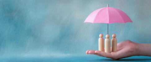 The umbrella protecting wooden figures symbolizing care and community support photo
