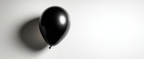 The elegant black balloon casting a soft shadow on a minimalistic background. photo